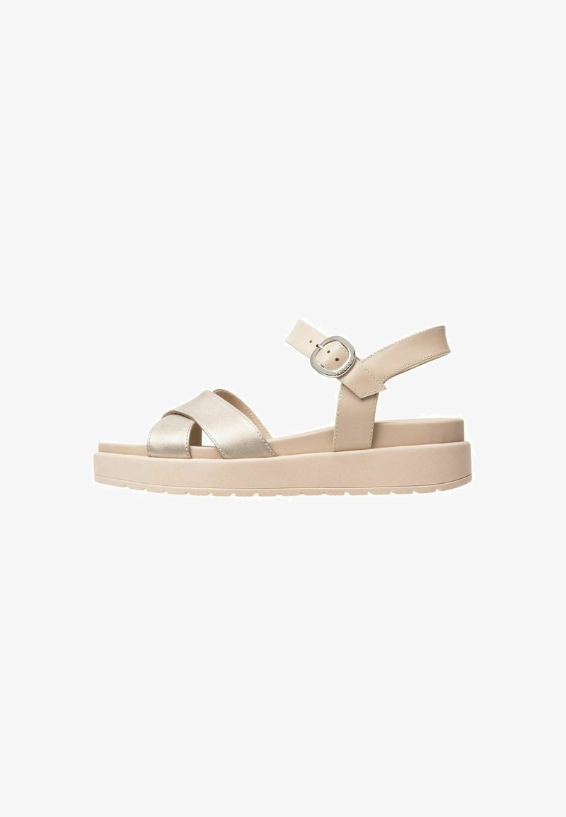 Beige platform sandals with a metallic cross strap design, adjustable ankle strap, and a textured sole for grip.