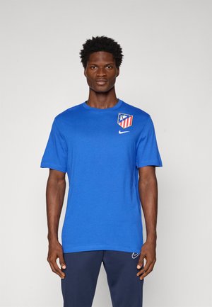 Blue Nike t-shirt with short sleeves, featuring a logo and design detail on the upper left chest area. Material appears smooth and lightweight.
