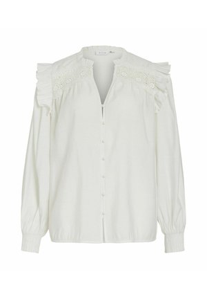 Blusa blanca con botones en la parte delantera, hombros con volantes y un intrincado encaje en el escote. Tejido suave y mangas largas.