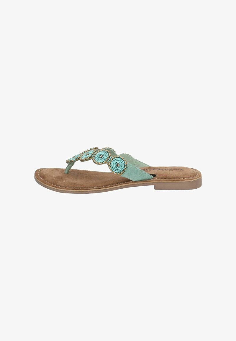 Flad sandal med stropper i lys grøn farve og perleformede cirkulære detaljer. Blød ruskindsfodbed og tan gummisål.