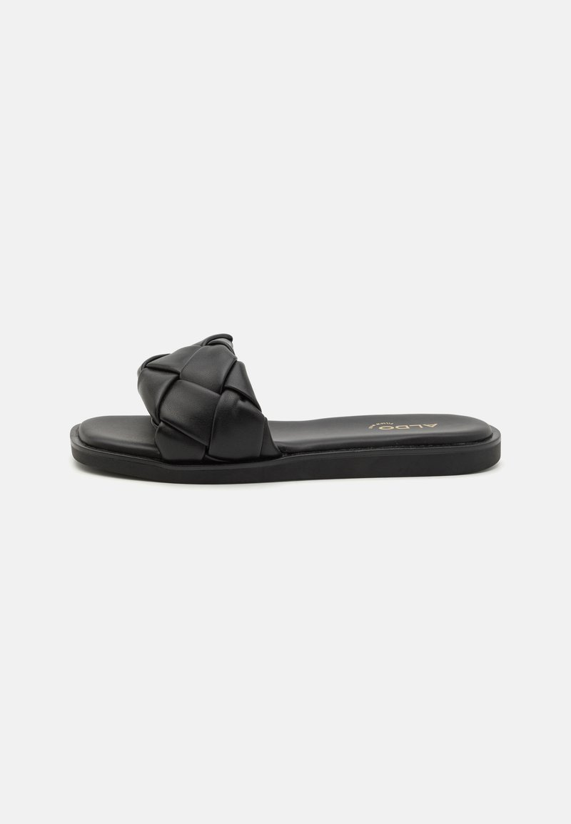 Sandalo slide nero con una cinghia intrecciata e imbottita, suola piatta e design minimalista. Il materiale sembra essere in finta pelle. Nessuna ferramenta visibile.