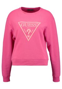 Różowy sweatshirt z okrągłym dekoltem, ściągaczami przy mankietach i na dole. Z przodu widnieje trójkątny logo w jaśniejszym odcieniu różowego.