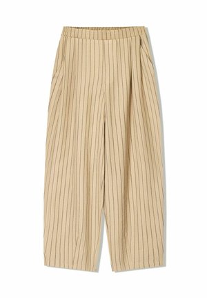 Beige striped trousers with an elastic waistband, featuring two side pockets, a loose fit, and vertical black pinstripes for detail.