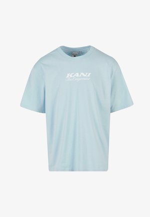 Heledasinine lühikeste varrukatega t-särk, mis on valmistatud puuvillast. Omab ümarat kaelaauku ja rinnal on valge trükitud tekst "KANI The Originator".