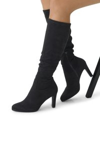 Black suede knee-high boots with a pointed toe, high heel, and side zipper detail, featuring a smooth texture and fitted design.