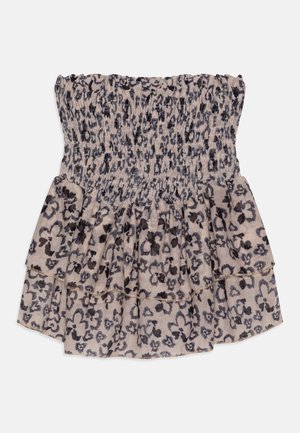 Haut bustier à smocks beige et noir à motif floral avec ourlet volanté en couches sur fond blanc.