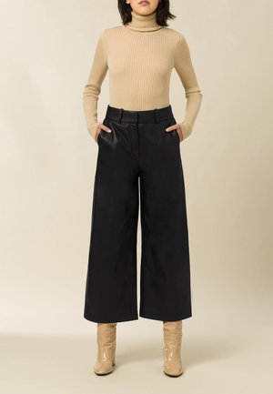 LILA - Leather trousers - black