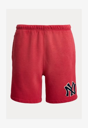 Red cotton shorts with elastic waistband and navy blue interlocking "NY" logo on the lower left leg.