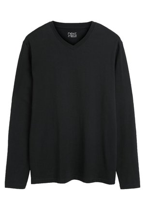 T-shirt noir à manches longues avec col en V et coupe régulière, étiqueté "Next The Essential Tee" en taille M.
