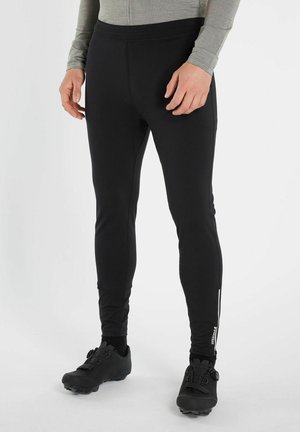 Zwarte sportbroeken van rekbaar materiaal, met een slim fit, elastische tailleband en ritssluiting op de onderkant van het been.