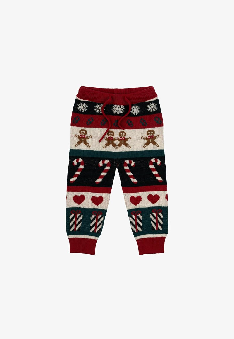Gestrickte festliche Hosen im rot-grünen Farbschema. Enthält Muster von Lebkuchenmännern, Zuckerstangen, Herzen und Schneeflocken.