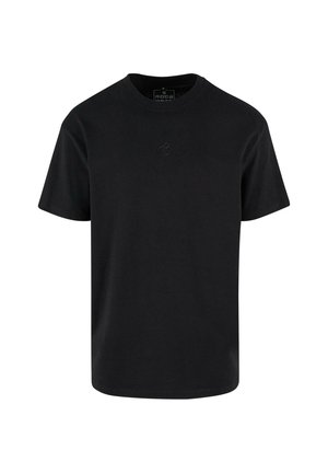 T-shirt en coton noir avec un col rond, des manches courtes et un logo en relief subtil sur la poitrine. Coupe régulière avec ourlet droit.