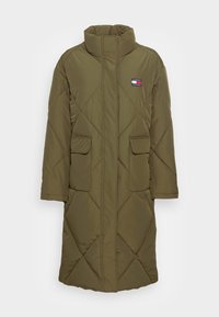 Olive green quilted long coat with a high collar, two front pockets, and a small logo patch on the left chest. Soft fabric texture.