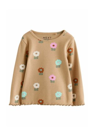 Langarm geribbelde top in lichtbruin met bloemenpatronen in roze, wit, blauw en bruin. Golfachtige zoom, ronde hals.