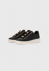 Black synthetic sneakers feature gold hardware, round laces, and a white sole with a gold accent. Smooth texture, low-top design.
