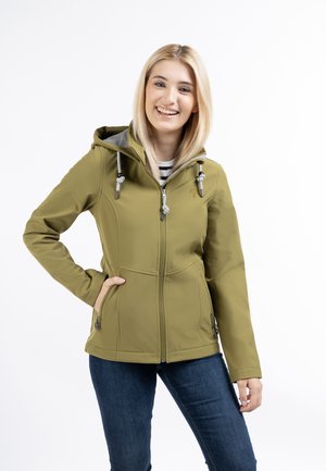 Khaki softshell jacket with a hood, featuring zipper pockets, drawstrings, and a slightly fitted design. Worn with dark jeans.