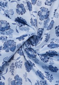 Tessuto azzurro chiaro con un design floreale in blu scuro. Include vari motivi e trame floreali, creando un aspetto coeso e intricato.
