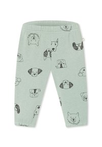 Light green cotton leggings featuring a pattern of various dog faces in black outline. Elastic waistband and snug fit at the ankles.