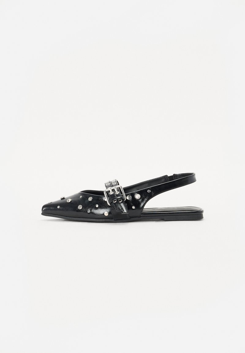 Sapato slingback preto em couro verniz com bico pontiagudo, detalhes com tachas prateadas e uma fivela na alça. Sola plana.