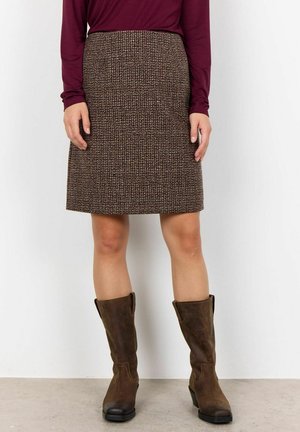 Brown tweed pencil skirt with a textured pattern, paired with knee-high brown leather boots. The outfit has a fitted silhouette.
