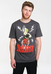 Grey cotton t-shirt featuring a graphic of a cartoon character with wings, lightning bolts, and red "Asterix" text. Regular fit, crew neckline.