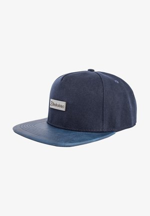 Navy blue cap featuring a flat bill and textured fabric. Includes a silver logo plaque on the front, with a smooth underside.