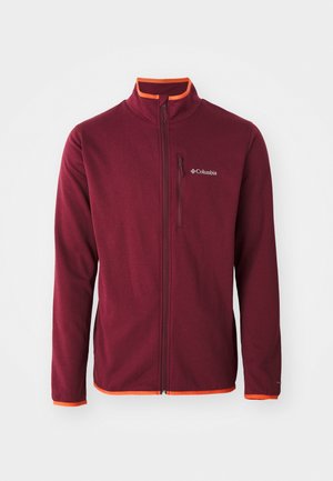 Burgundi värvi fliiskindel jakk, millel on tõmblukuga esiosa, oranžid aktsendid krae ja mansettide peal ning väike logo rinnal. Sile tekstuur, vormitud disain.