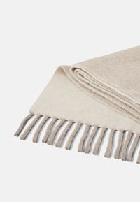 Fringed wool scarf in beige and light gray tones, featuring a soft texture and a folded design with neat stitching along the edges.