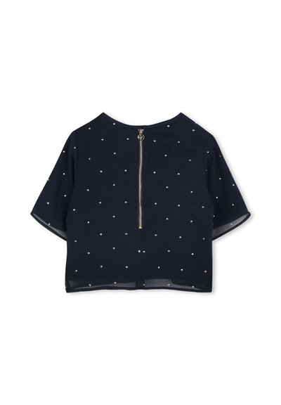 Haut à manches courtes bleu marine avec une fermeture éclair au dos, présentant un tissu texturé et des embellissements dorés dispersés pour un détail décoratif.