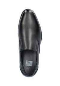 Black leather slip-on shoe with a smooth texture, round toe, elastic side panels, and a cushioned insole, featuring product label inside.