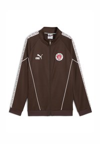 Chaqueta marrón con cremallera y acentos blancos, que presenta un logo redondo, texto "KING" y rayas laterales con patrón. Fabricada con material suave y ligero.