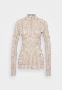 Lys beige termal genser med halv-glidelås krage, mønstrede ermer, ribbestrikkede mansjetter og sidelommer med teksturdetaljer.