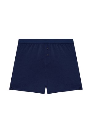 Boxers de color azul marino hechos de material suave, con cierre de botón y aberturas laterales para mayor comodidad y movilidad.