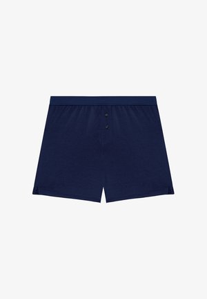 Boxer navy blu scuro realizzati in materiale morbido, con chiusura a bottoni e fessure laterali per comfort e mobilità.