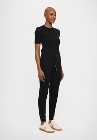 Armani Exchange TROUSER - Donji dijelovi trenirke - black/gold
