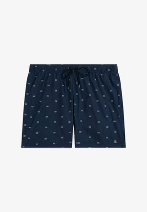 Marineblauwe zwembroek met een losse pasvorm, elastische taille, trekkoord en een klein contrasterend geometrisch patroon overal. Voorzien van zijzakken.