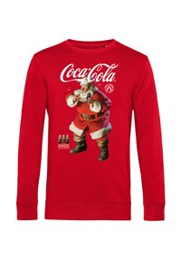 Červený svetr s dlouhým rukávem s grafikou Santy Clause, který drží láhev Coca-Coly, s bílými lemy na manžetách a límci.