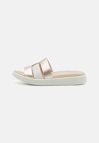 Light gold slide sandals with two wide straps, one metallic and one white, on a cushioned sole with a slightly elevated white base.
