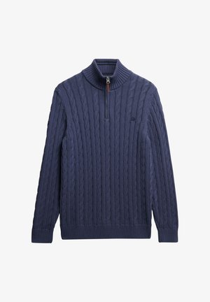 Pull en maille bleu marine avec un col haut, présentant des motifs en câble, une fermeture zippée à moitié et des poignets et un ourlet côtelés.