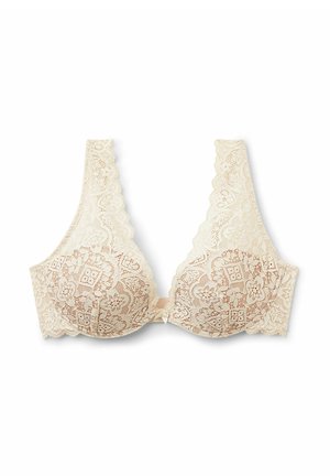 Beige blondebh med blomsterprint, brede skulderstropper, bølgede kanter og en lille sløjfekrave midt for.