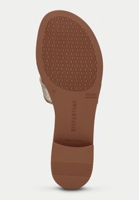 Brun gummisul med ett strukturerat mönster, märkt med "HISPANITAS" och "TRIFLOW", med en slät, rundad klack och sidokant.