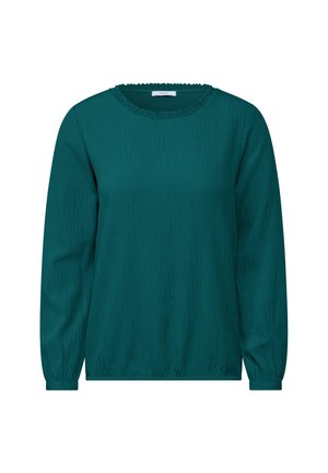 Teal långärmad blus i en texturerad tyg, rund halsringning och rynkade detaljer vid halsen och ärmsluten för en avslappnad passform.