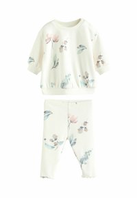 Sæt i bomuld til afslapning i creme farve med pink og blå blomsterprint. Det indeholder en kortærmet pullover og leggings med elastisk talje samt flæser ved kanten.