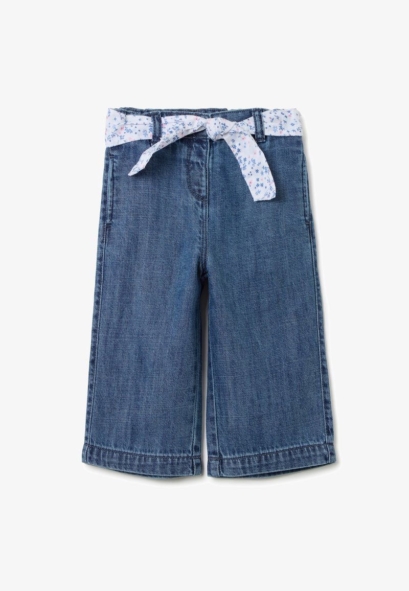 Culottes en denim avec une ceinture ornée d'un nœud à motifs floraux blancs. Tissu bleu foncé, coupe ample, avec des coutures et des ourlets visibles.