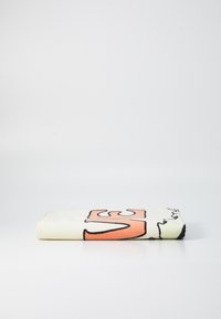 Brettet håndkle med en kremfarget bakgrunn, stort oransje grafikk, og svart kant. Myk tekstur med en illustrativ design.