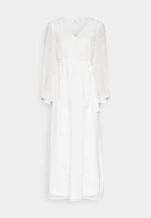 Bílé šaty s výstřihem do V a dlouhými průhlednými rukávy, vyrobené z texturované tkaniny, s páskem na zavazování v pase a potiskem puntíků.