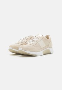 Baskets beige avec tige en suède et tissu, comprenant un détail pailleté, des lacets blancs et une semelle blanche rembourrée.