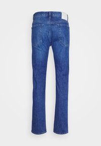 Jean en denim bleu avec jambes droites, deux poches arrière, passants de ceinture et une étiquette blanche sur la taille, vu de dos.