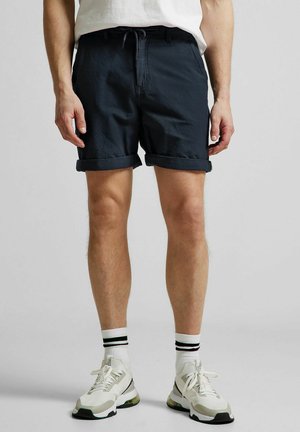 Navy blue shorts with rolled cuffs, made from textured fabric. Features an elasticated waistband with drawstring and side pockets.