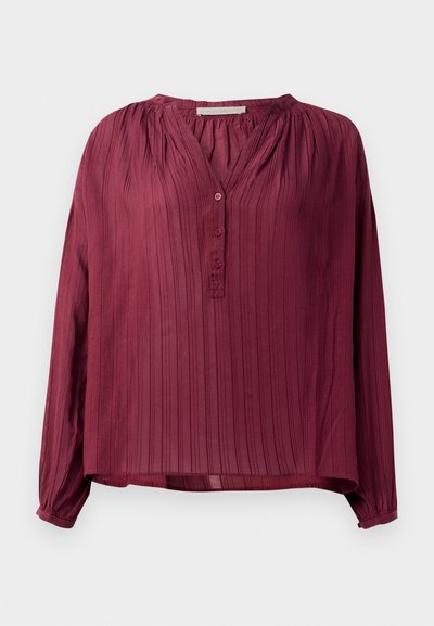 Bluză lungă cu mâneci burgundy, cu un design pliat, decolteu în V și trei butoane în față. Material ușor, cu un luciu subtil.